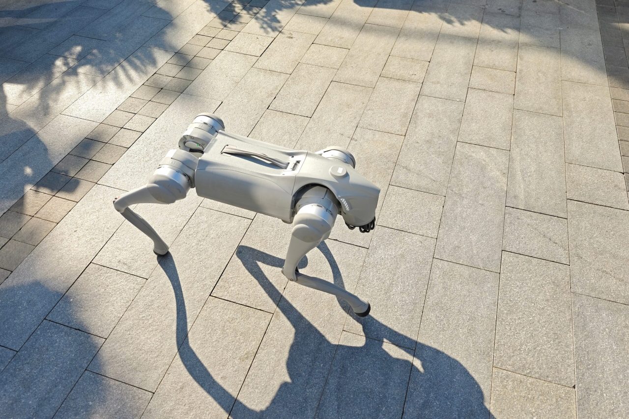 A quadruped robot with artificial intelligence carrying out an autonomous industrial inspection inside a production facility.